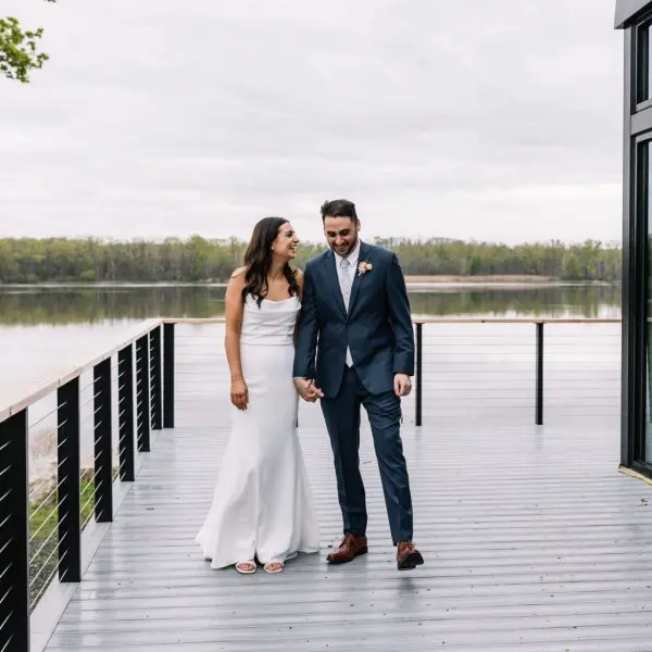 Bridge and groom holding hands on deck