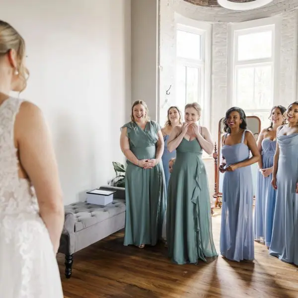 bridal party reacts to seeing bride in dress