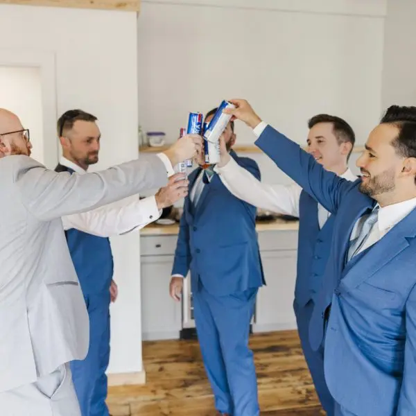 Grooms men cheersing drinks