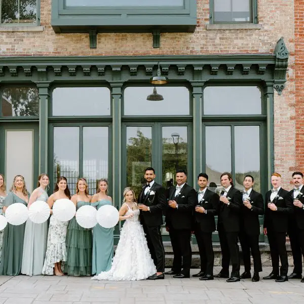Wedding party pose with bride and groom
